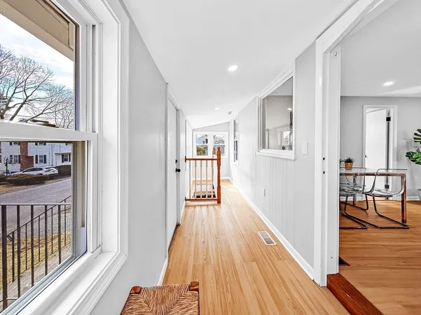 a view of an entryway with wooden floor and windows