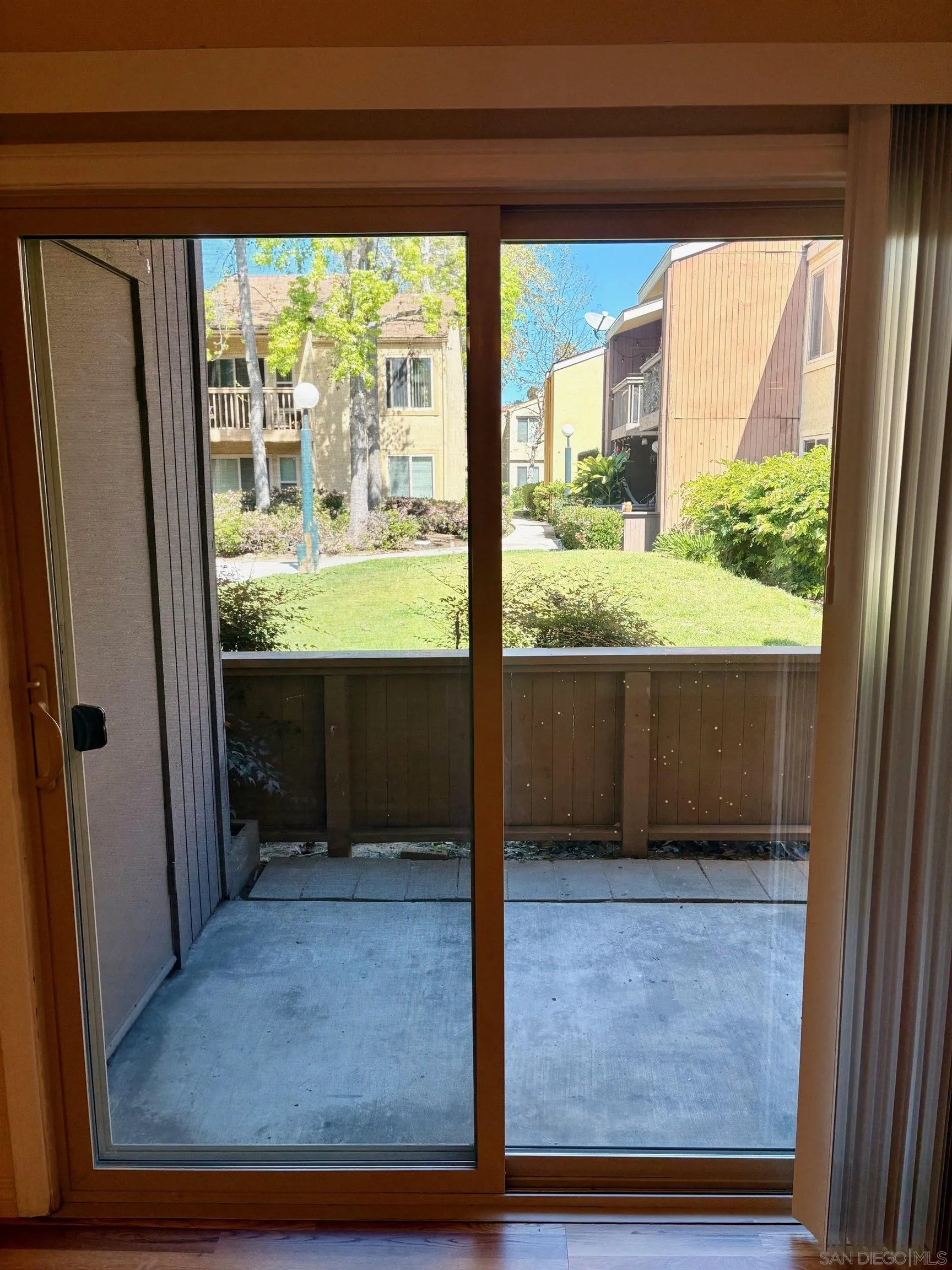 5946 Rancho Mission Road, Unit 149 San Diego, CA 92108 - Photo 3 of 23 Looking out from Living Room to Peaceful Green