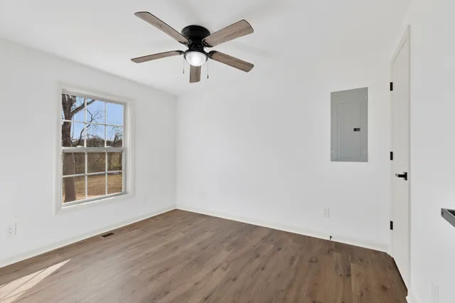 wooden floor in an empty room with a window