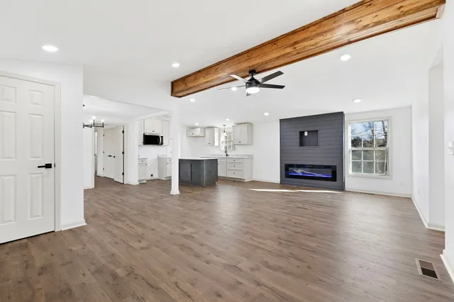 a view of a kitchen with a sink and a refrigerator