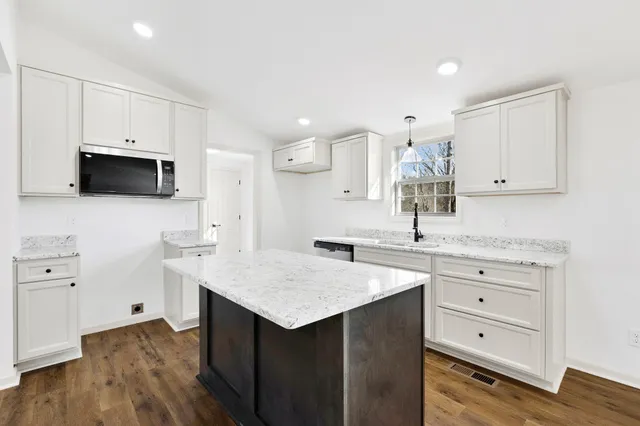 a view of livingroom with hardwood floor and hallway