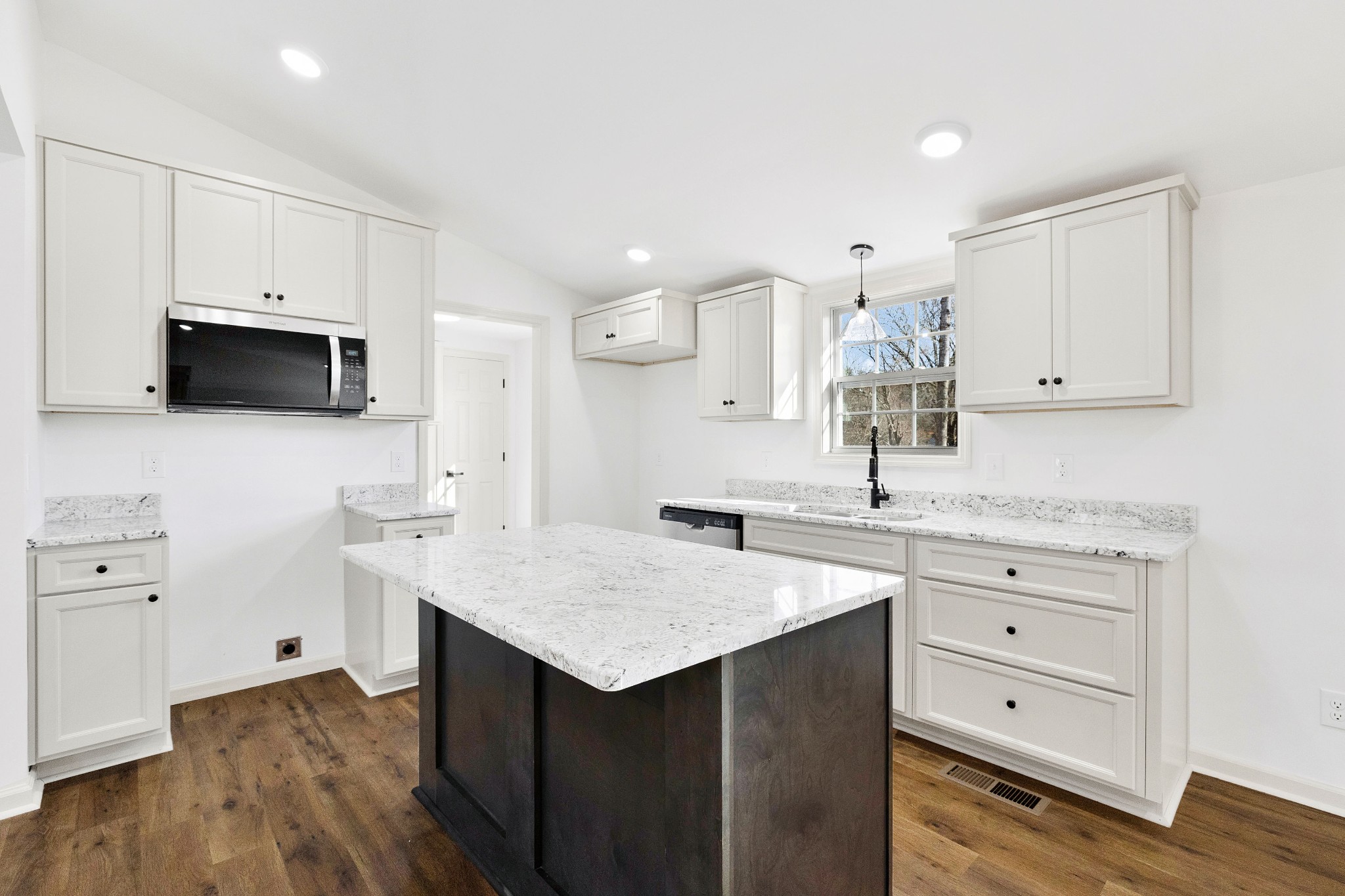 462 Circle Drive Prospect, TN 38477 - Photo 7 of 29 a kitchen with granite countertop a sink cabinets and wooden floor