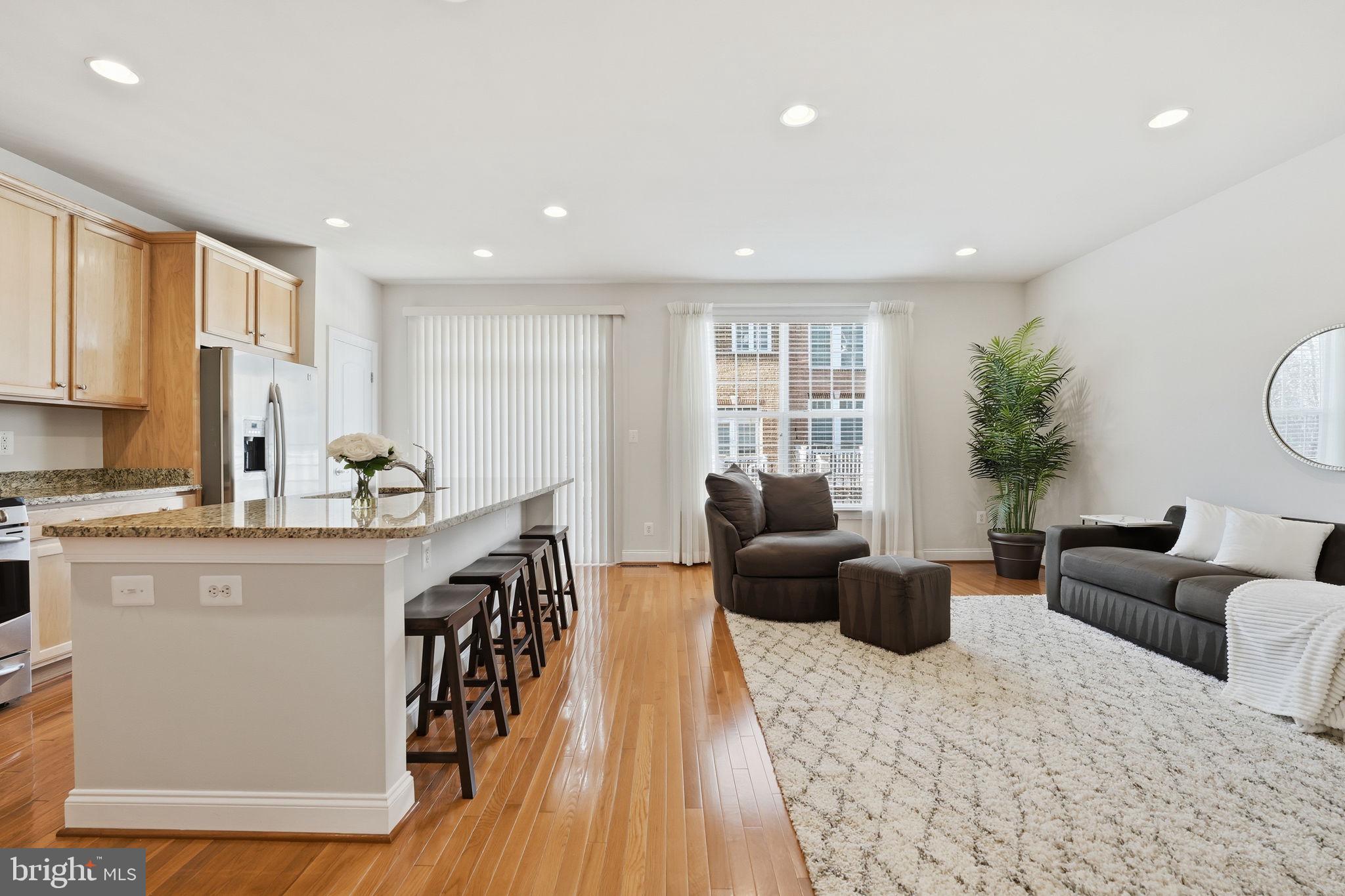 8015 Reserve Way Vienna, VA 22182 - Photo 13 of 58 a living room with furniture a large window and wooden floor