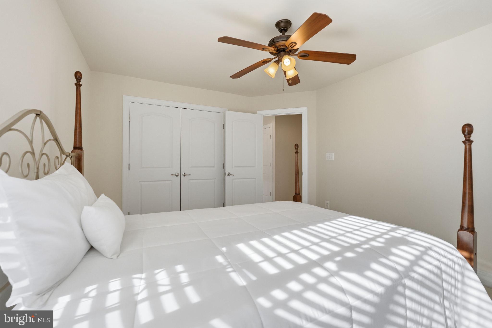 8015 Reserve Way Vienna, VA 22182 - Photo 30 of 58 a bedroom with a large bed and a chandelier