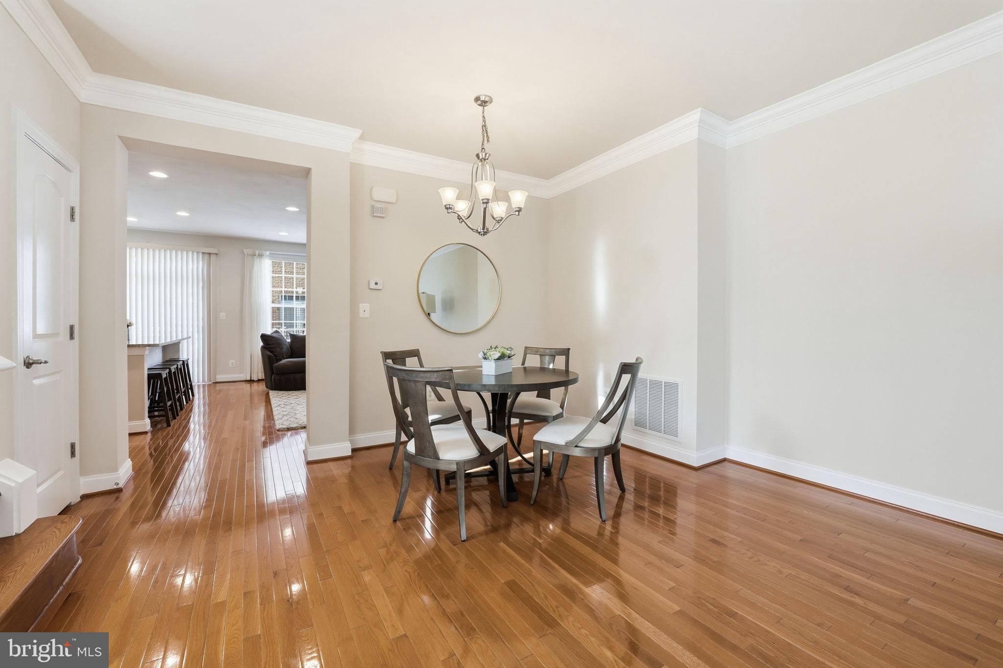 8015 Reserve Way Vienna, VA 22182 - Photo 10 of 58 a view of a dining room with furniture and wooden floor