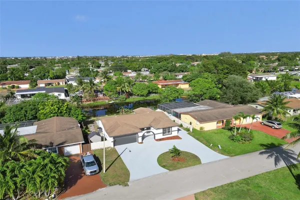 an aerial view of residential houses with outdoor space and street view