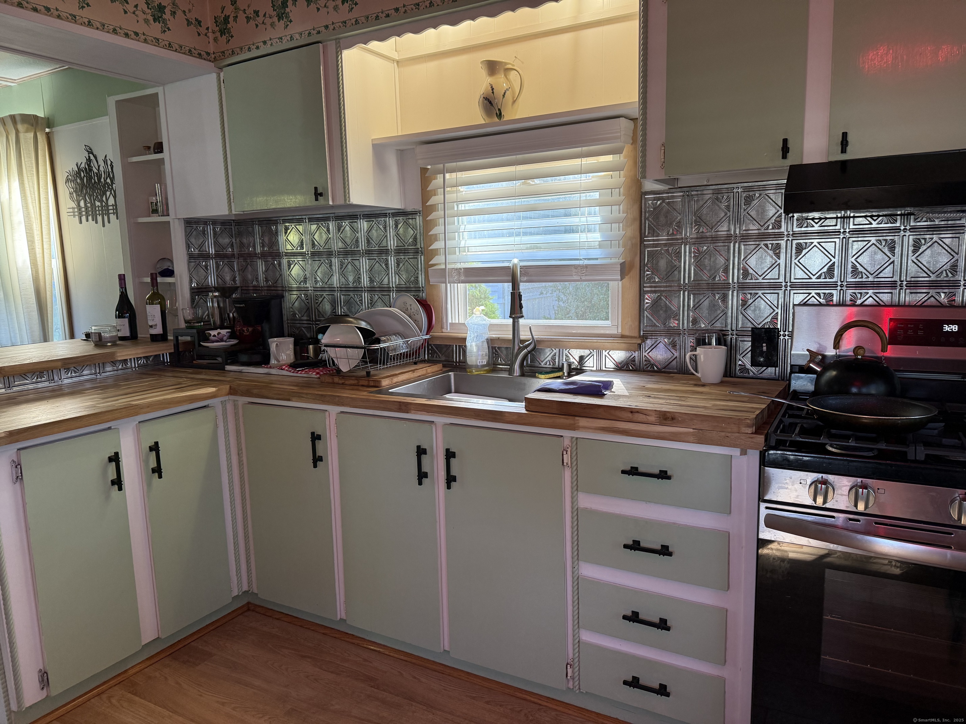 10 Whitewood Road Killingworth, CT 06419 - Photo 3 of 12 a kitchen with a sink stove and cabinets