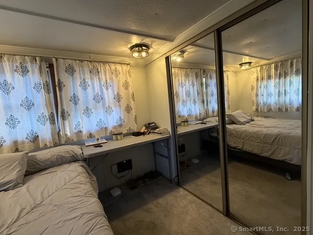 a bedroom with a bed and a table