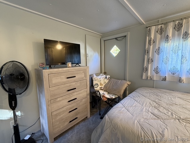 10 Whitewood Road Killingworth, CT 06419 - Photo 8 of 12 a bedroom with a bed and a flat tv screen on wall