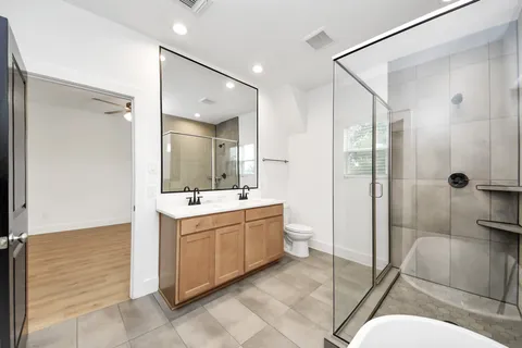 a view of a house with backyard and wooden fence