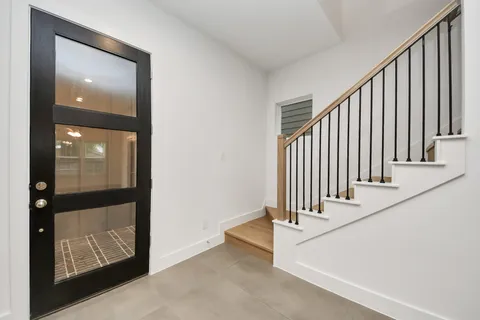 a large kitchen with stainless steel appliances kitchen island a large counter top and a sink