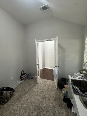 a hallway with a view of bedroom with a window
