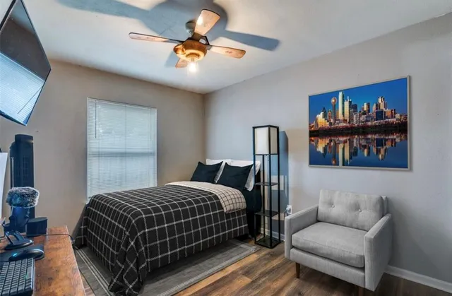 a bedroom with a bed and a painting on the wall