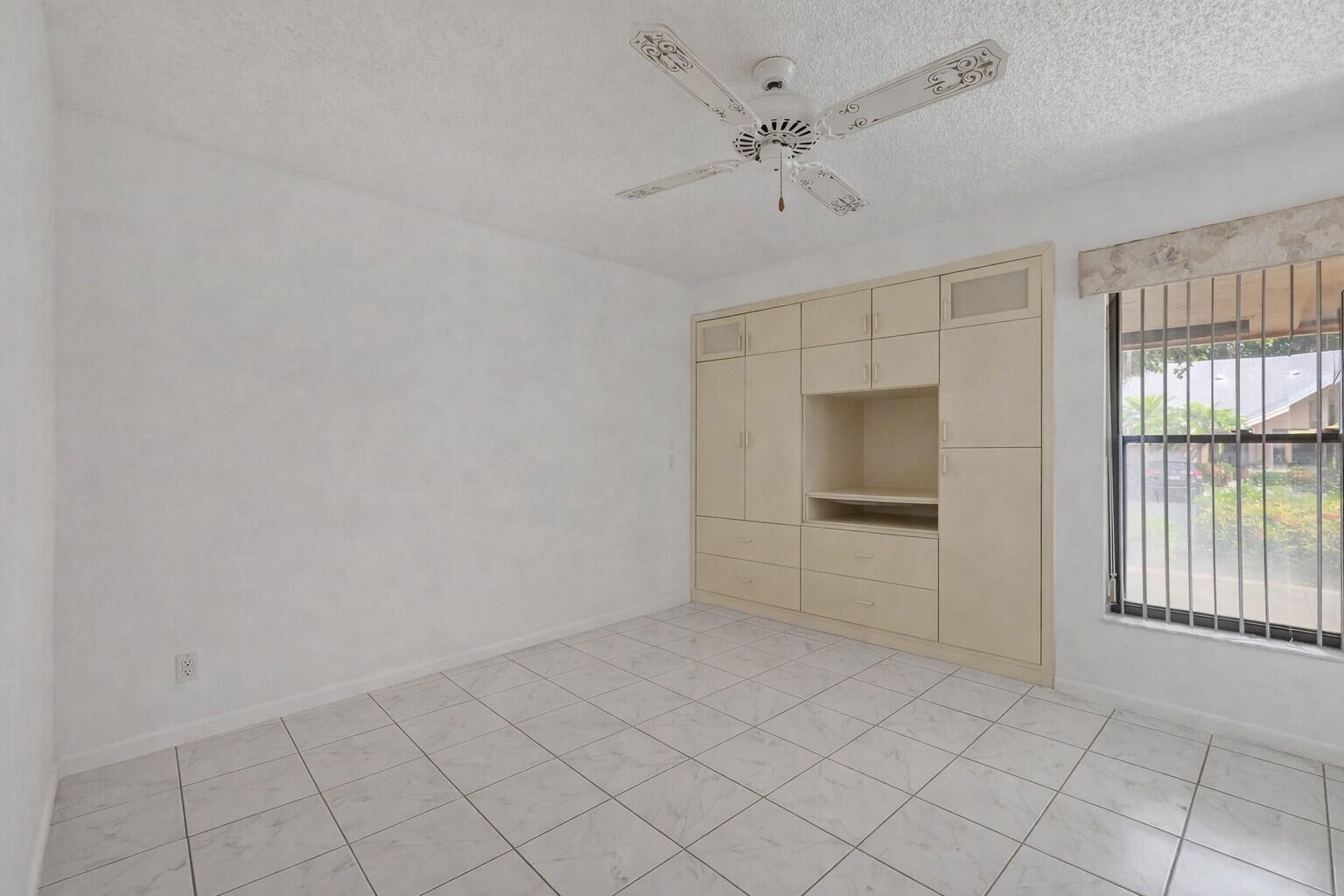 10884 Waterberry Court Boca Raton, FL 33498 - Photo 25 of 39 an empty room with windows and fan