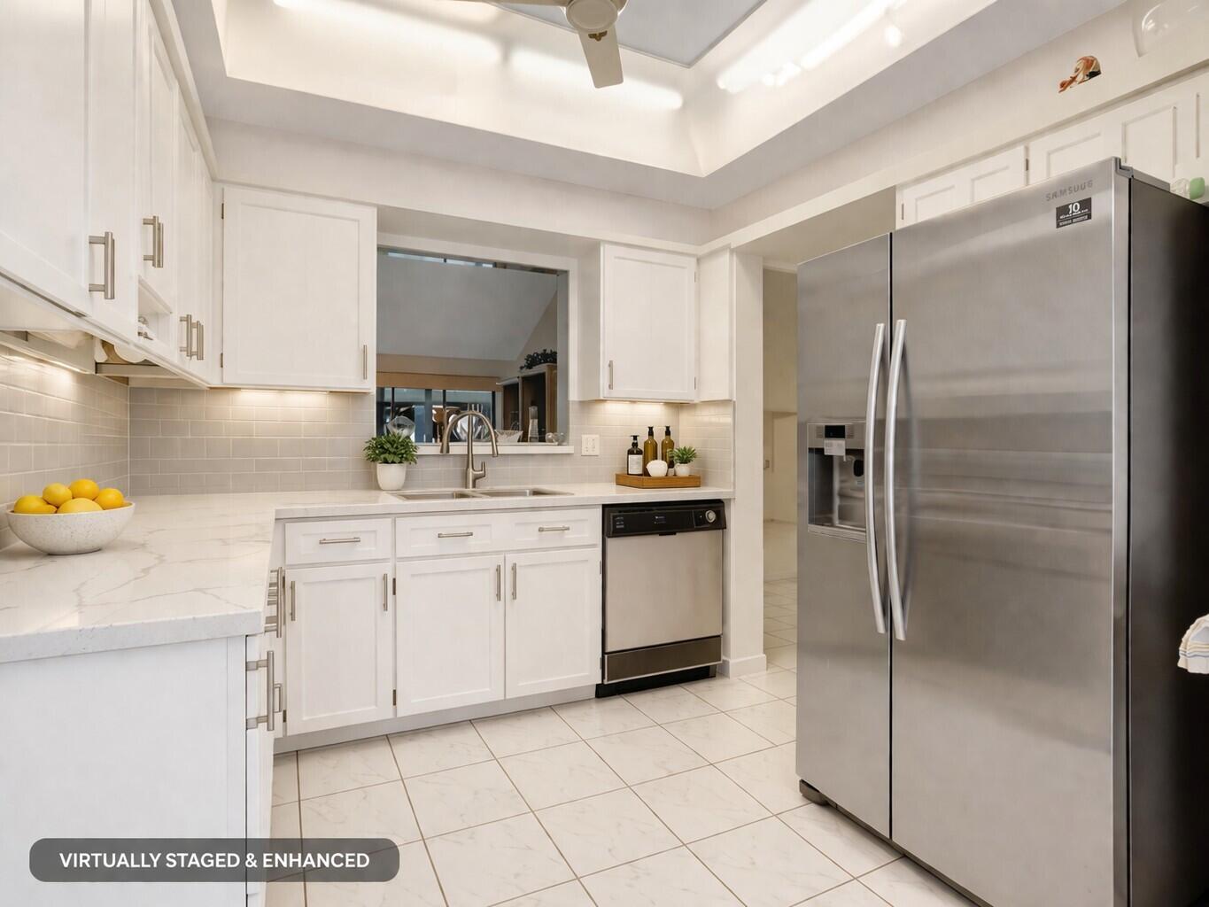 10884 Waterberry Court Boca Raton, FL 33498 - Photo 9 of 39 a kitchen with a refrigerator sink and cabinets