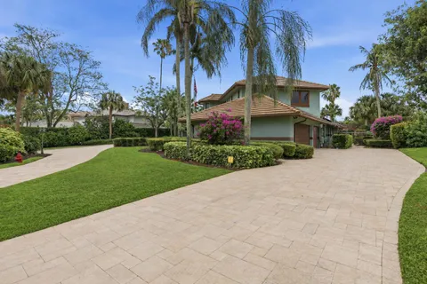 a view of a house with a yard and sitting area