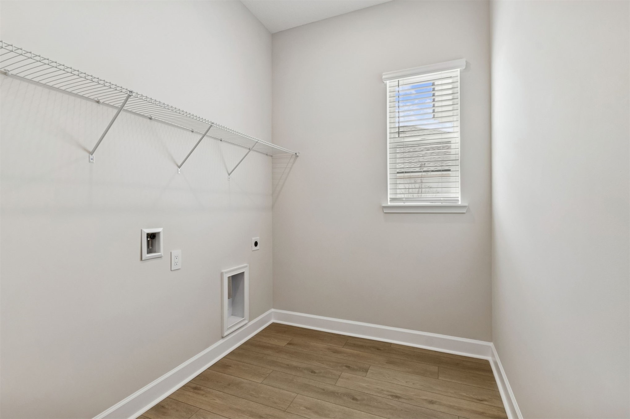 85228 Sandy Rdg Loop Yulee, FL 32097 - Photo 21 of 24 a view of an empty room with wooden floor and a window
