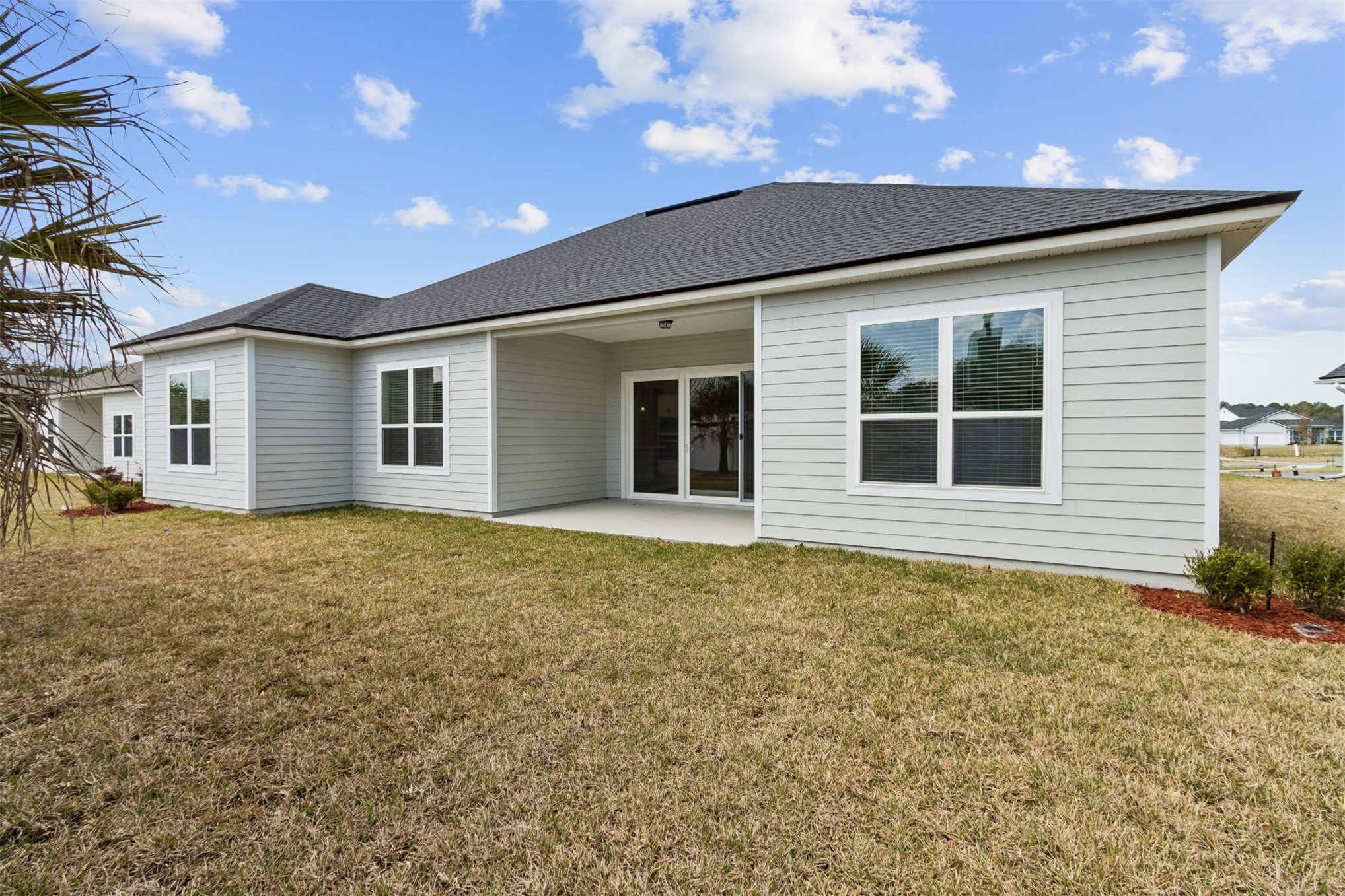 85228 Sandy Rdg Loop Yulee, FL 32097 - Photo 23 of 24 a view of a house with a backyard