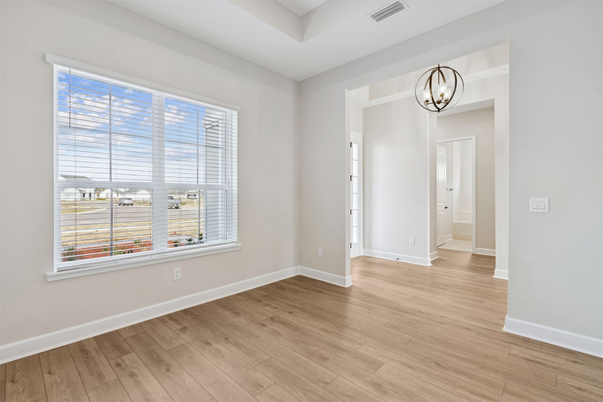 85228 Sandy Rdg Loop Yulee, FL 32097 - Photo 7 of 24 a view of an empty room with wooden floor and a window