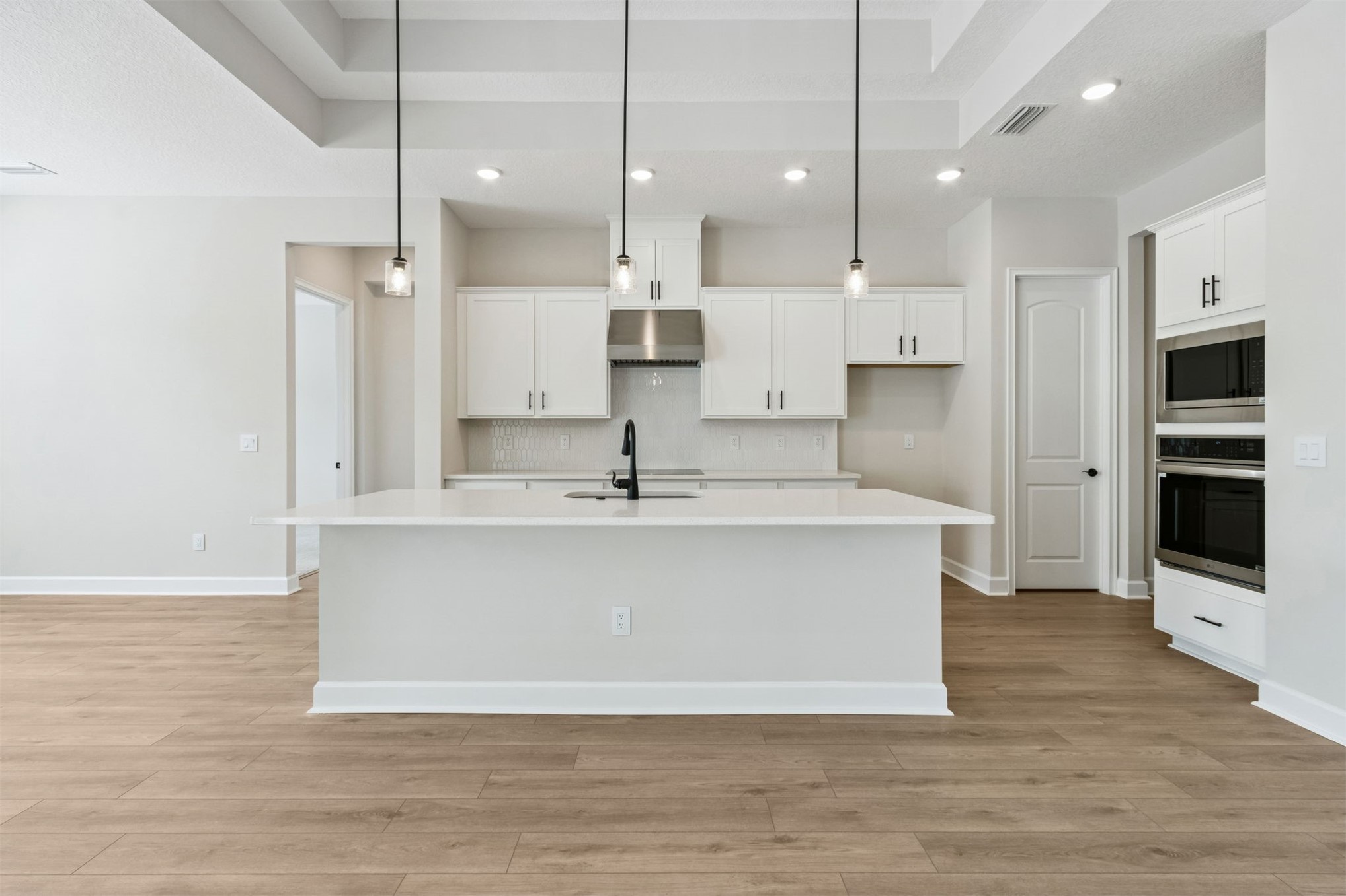 85228 Sandy Rdg Loop Yulee, FL 32097 - Photo 9 of 24 a view of kitchen with stainless steel appliances granite countertop a sink a oven a stove and a refrigerator with wooden floor