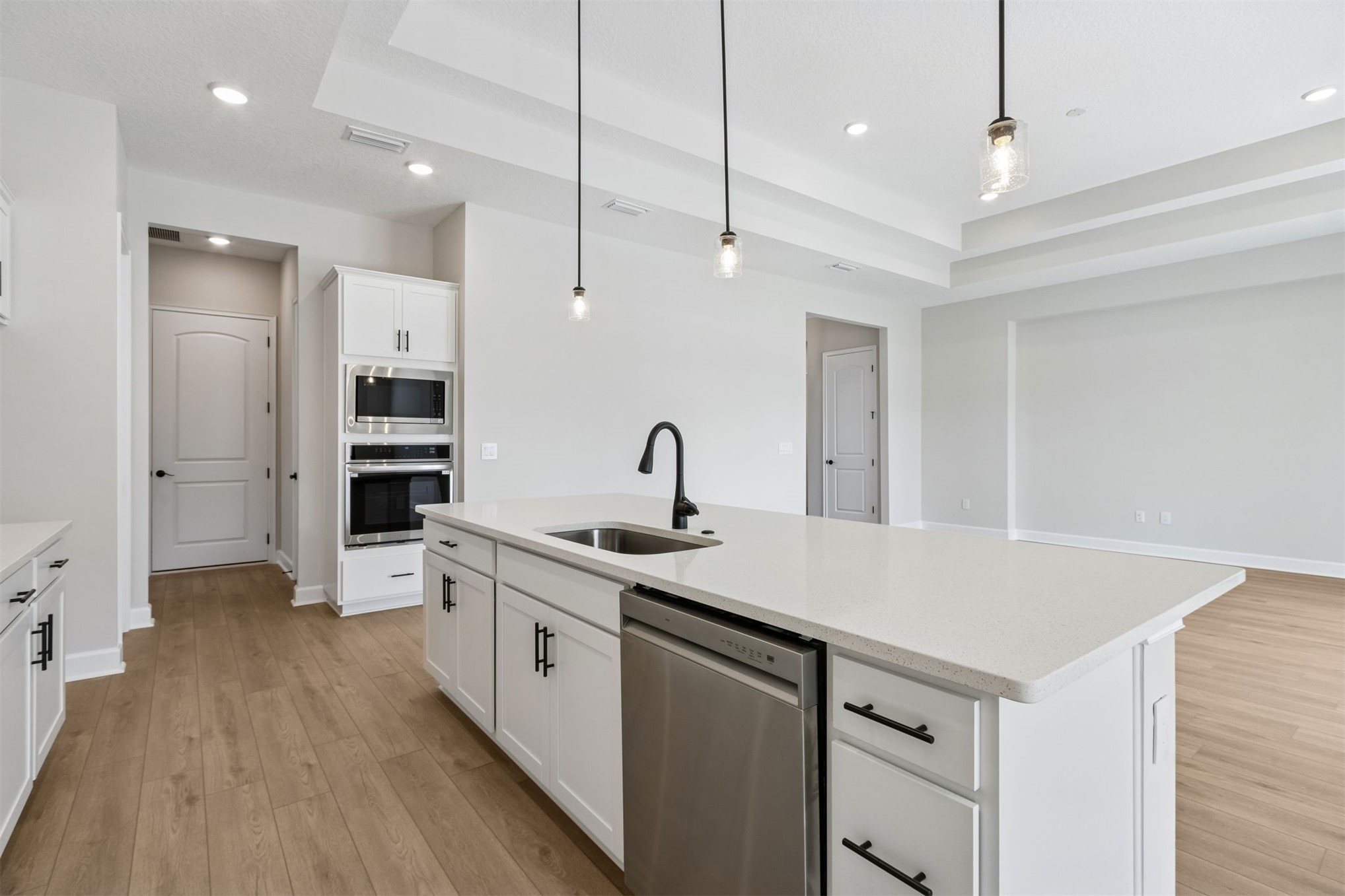 85228 Sandy Rdg Loop Yulee, FL 32097 - Photo 10 of 24 a large white kitchen with a sink a refrigerator and a stove
