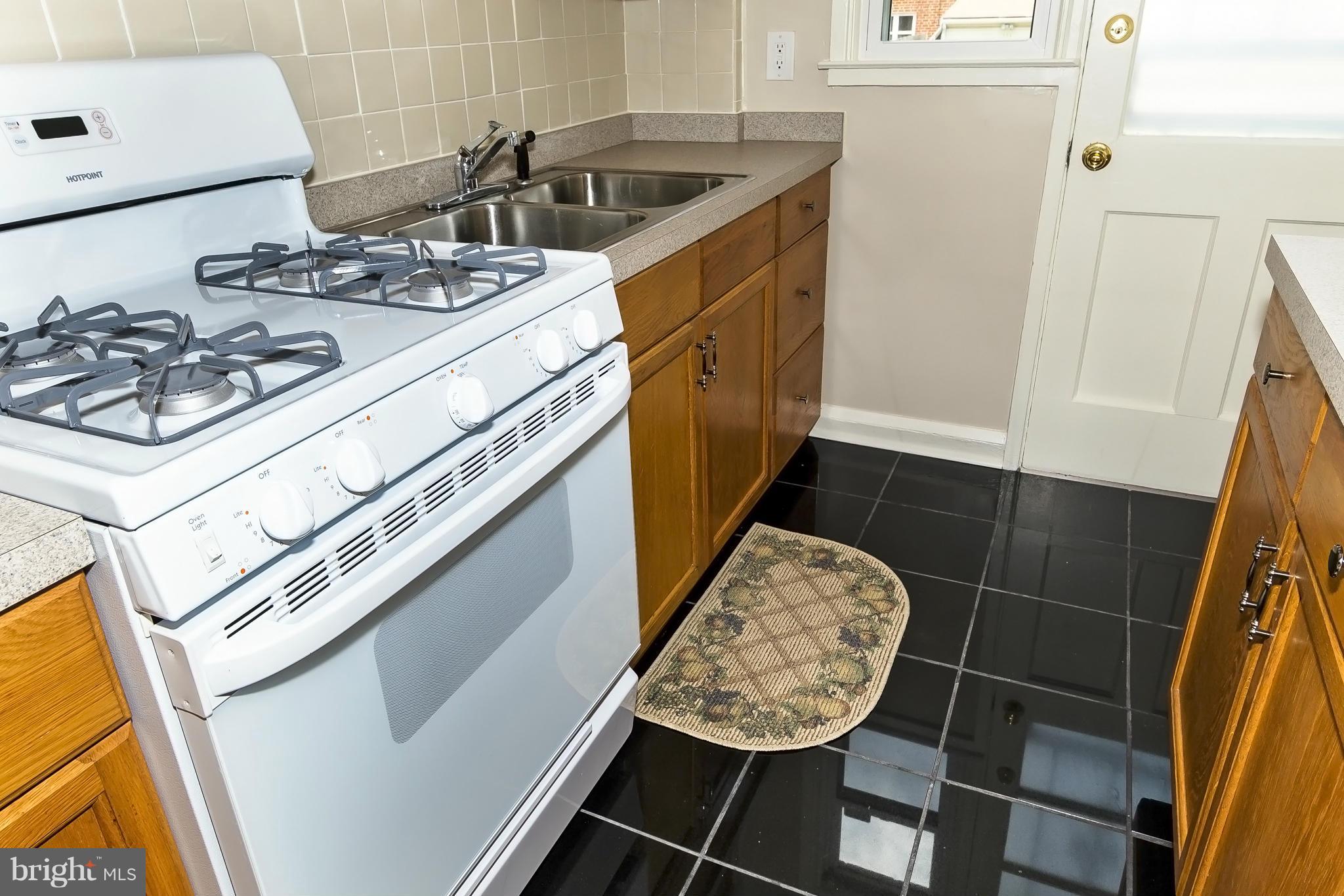 607 Brisbane Road Baltimore, MD 21229 - Photo 14 of 28 a kitchen with a stove and a sink