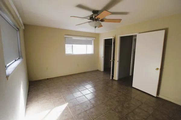 a view of a livingroom with a ceiling fan and window