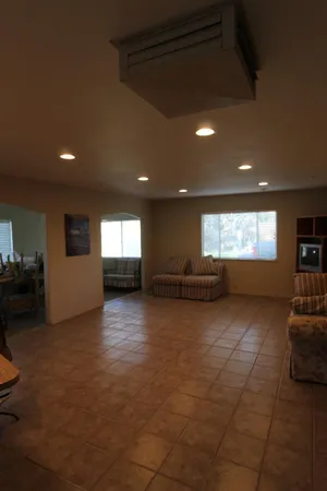a view of empty room with wooden floor and windows