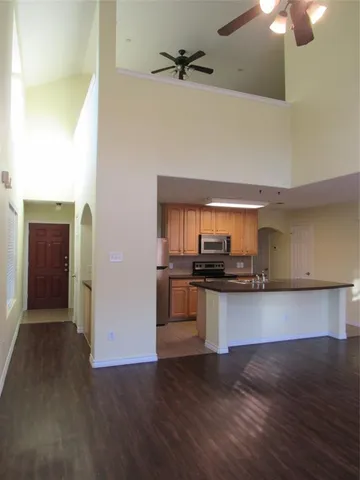 a kitchen with stainless steel appliances a stove a microwave and wooden floor