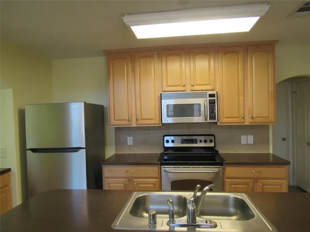 a kitchen with a refrigerator and a sink