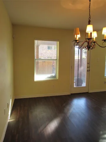 a view of a livingroom with furniture wooden floor and windows