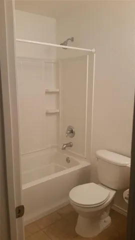 an empty room with wooden floor mirror and closet