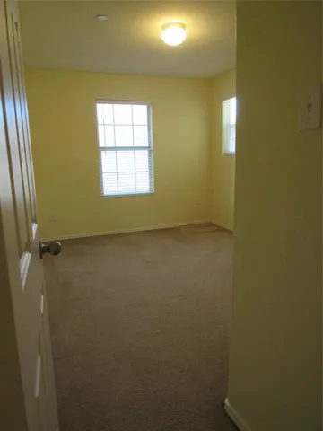 an empty room with a empty space and windows