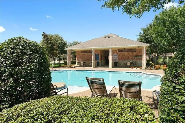 a backyard of a house with table and chairs