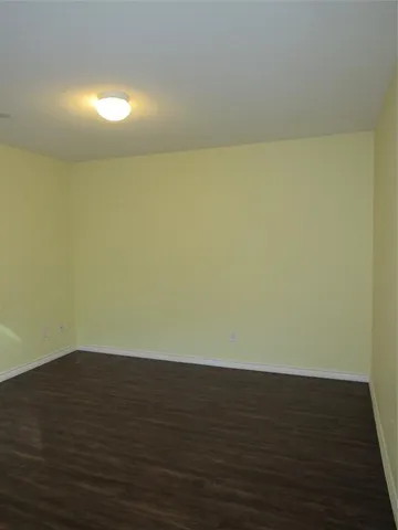 a view of an empty room and wooden floor