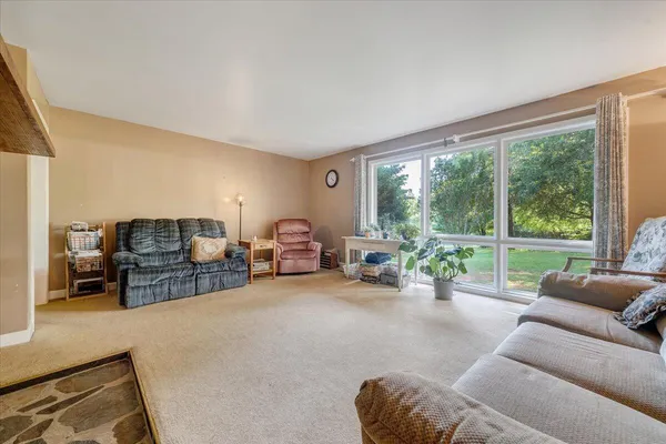 a view of a livingroom with furniture and a window