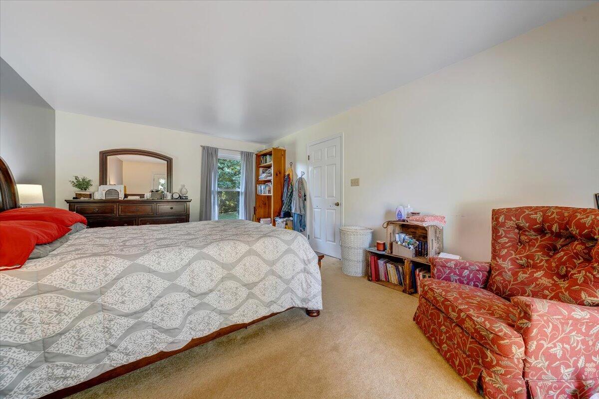 404 Robin Ridge Road Rocky Mount, VA 24151 - Photo 22 of 56 a spacious bedroom with a bed and a couch