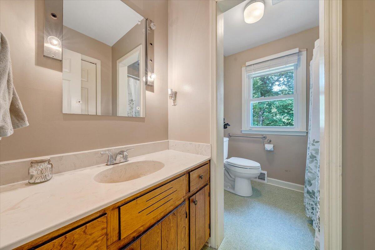 404 Robin Ridge Road Rocky Mount, VA 24151 - Photo 23 of 56 a bathroom with a sink toilet vanity and a window