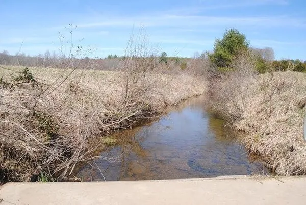a kitchen with stainless steel appliances a sink window and cabinets