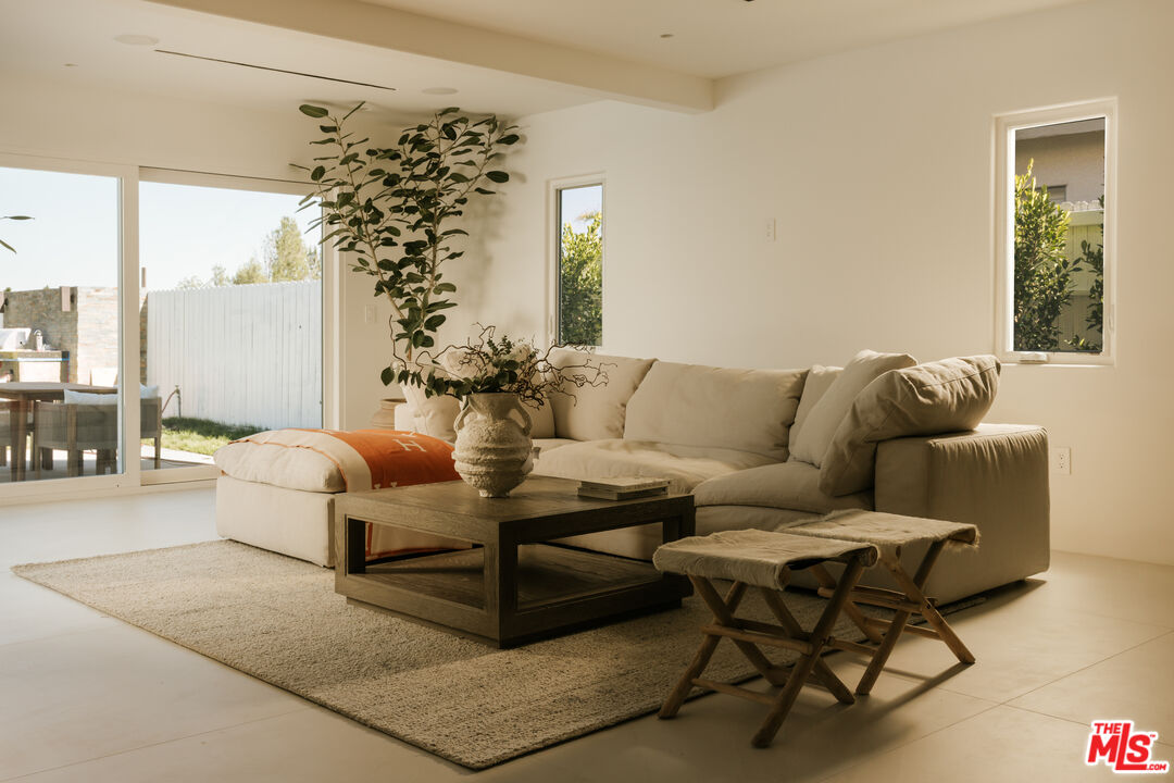 880 Teakwood Road Los Angeles, CA 90049 - Photo 14 of 38 a living room with furniture and a large window