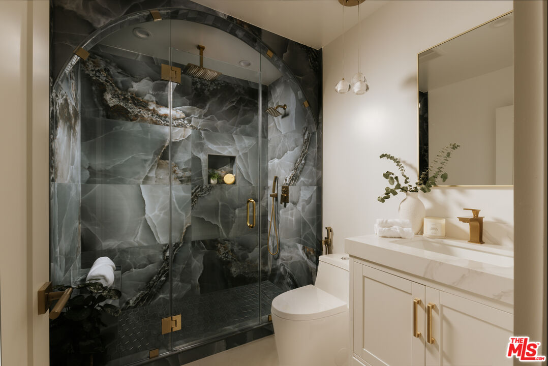 880 Teakwood Road Los Angeles, CA 90049 - Photo 29 of 38 a bathroom with a granite countertop sink toilet and shower
