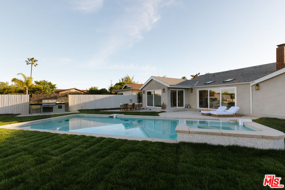 880 Teakwood Road Los Angeles, CA 90049 - Photo 30 of 38 a view of house with outdoor space and swimming pool