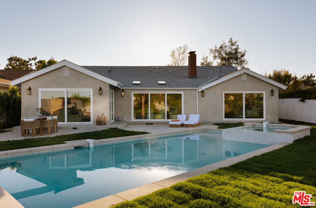 880 Teakwood Road Los Angeles, CA 90049 - Photo 33 of 38 a front view of a house with swimming pool and porch
