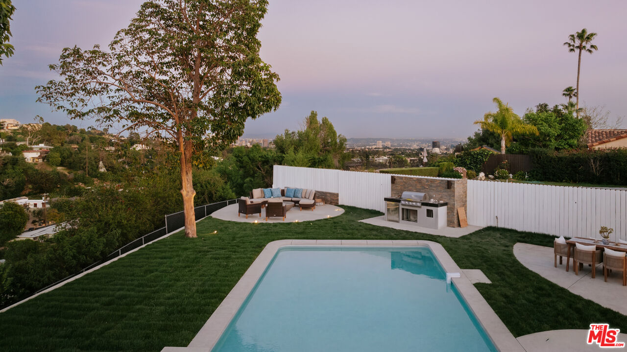 880 Teakwood Road Los Angeles, CA 90049 - Photo 34 of 38 a view of a backyard with couches and city view