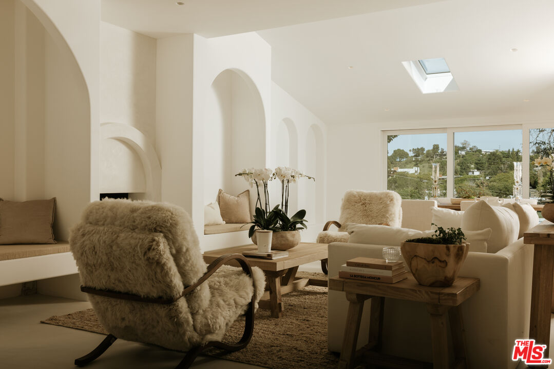 880 Teakwood Road Los Angeles, CA 90049 - Photo 5 of 38 a living room with furniture and large windows