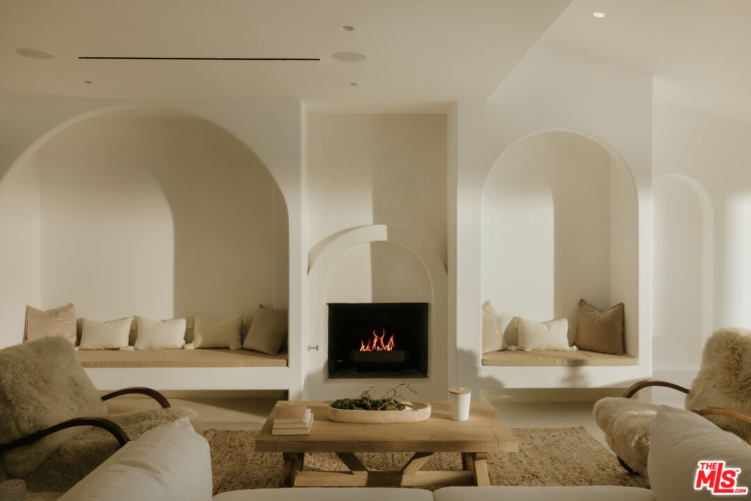 880 Teakwood Road Los Angeles, CA 90049 - Photo 6 of 38 a living room with furniture and a fireplace
