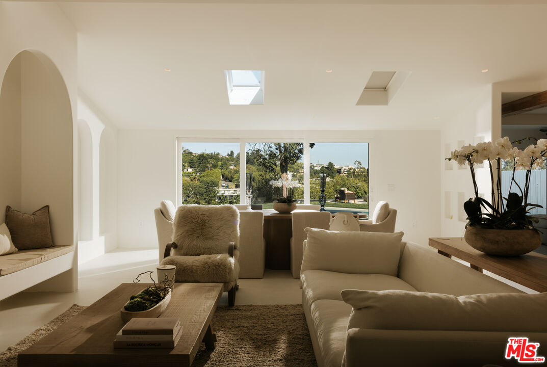 880 Teakwood Road Los Angeles, CA 90049 - Photo 7 of 38 a living room with furniture and a flat screen tv