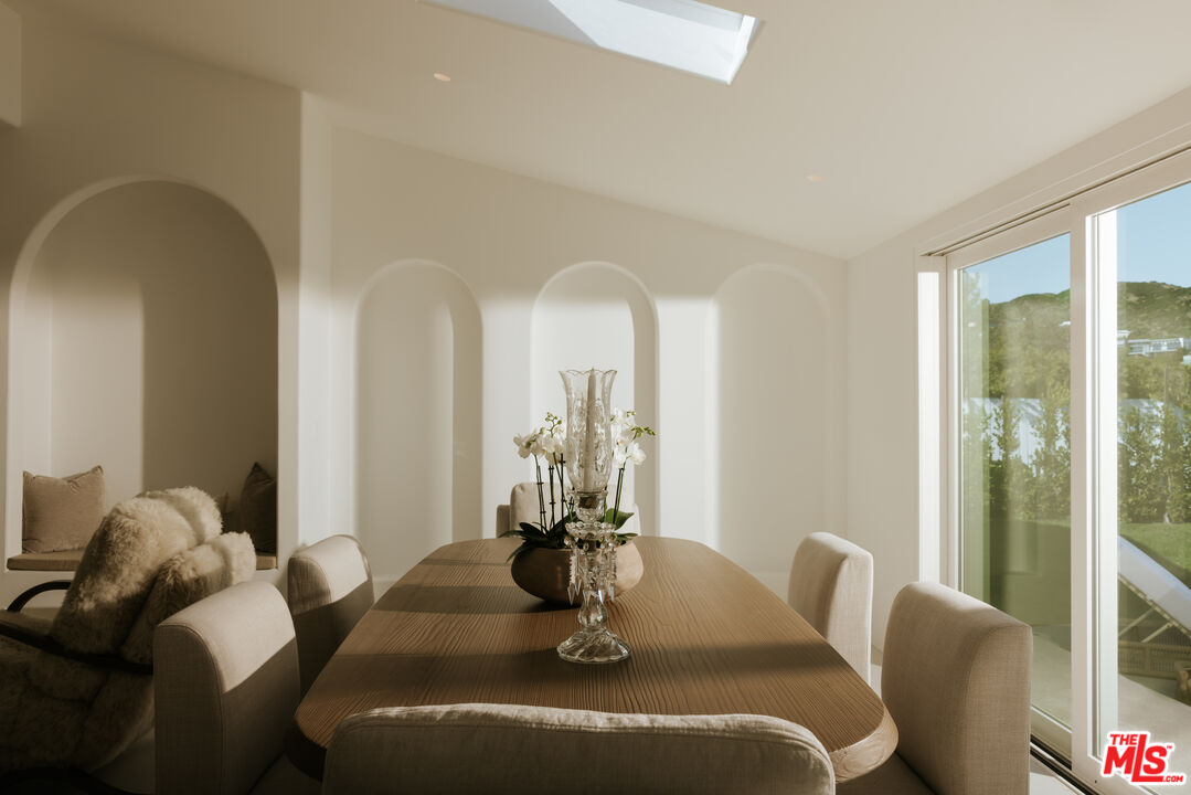 880 Teakwood Road Los Angeles, CA 90049 - Photo 9 of 38 a dining room with furniture and wooden floor