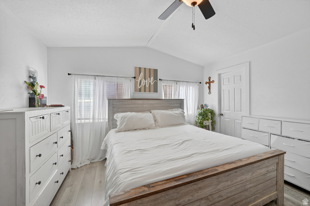 160 Cushing Way Layton, UT 84041 - Photo 14 of 23 Vaulted ceiling bedroom featuring wood-finish flooring, a ceiling fan with integrated lighting, and multiple windows with blinds