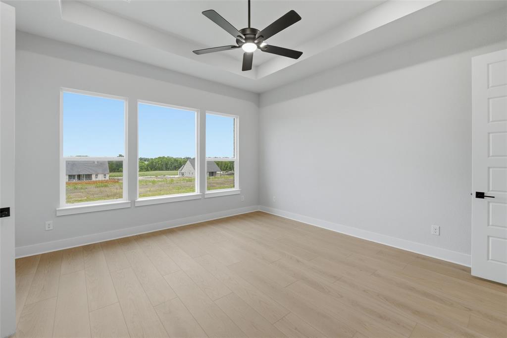 809 Vly Rdg Road Van Alstyne, TX 75495 - Photo 11 of 30 an empty room with a window and a fan